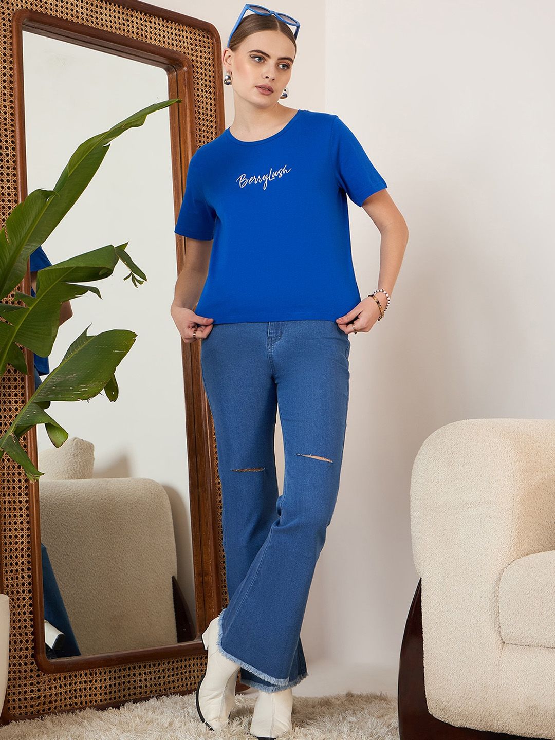 Berrylush Blue Women Bootcut High-Rise Mildly Distressed Stretchable Light Fade Jeans