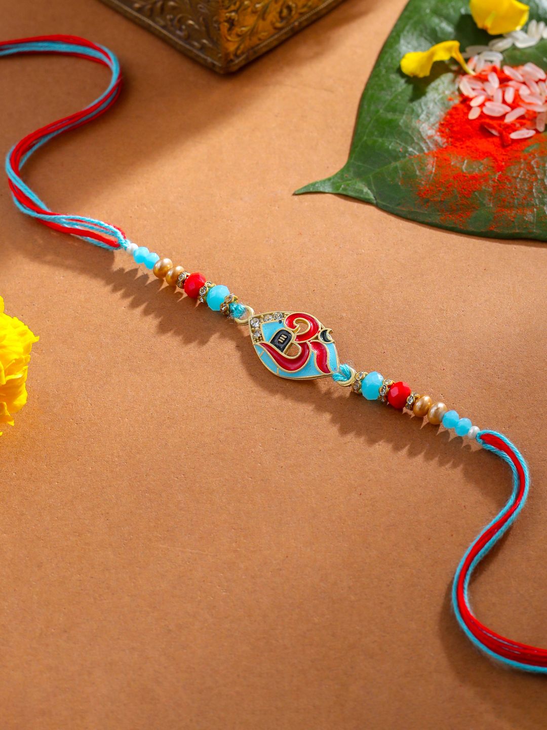 NVR Unisex Red & Blue Artificial Stones and Beads Om Thread Rakhi With Roli Chawal