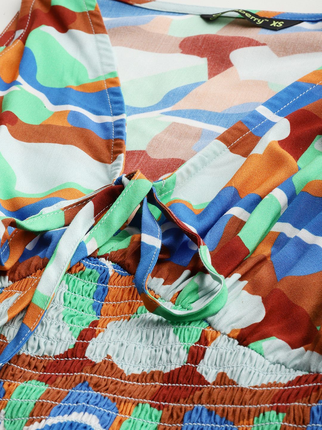 DressBerry Playful Palette  Abstract Printed Tie-Up Neck Smocked Top