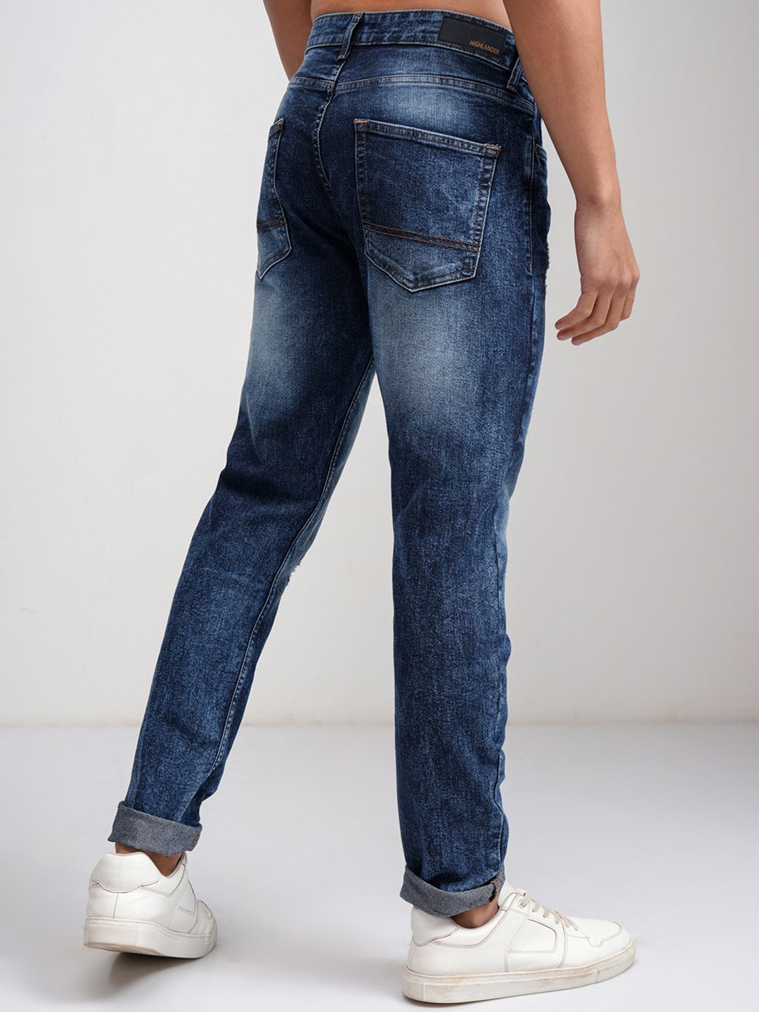 HIGHLANDER Men Blue Tapered Fit Mid-Rise Mildly Distressed Light Fade Stretchable Jeans