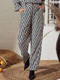 SASSAFRAS Women Beige & Black Geometric Printed Mid-Rise Trousers