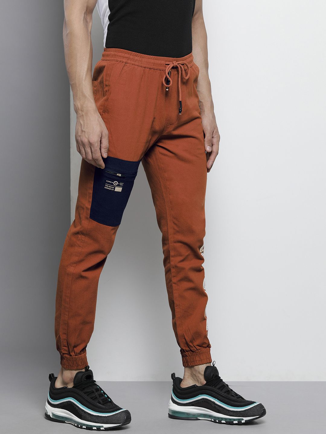 The Indian Garage Co Men Rust Orange Colourblocked Slim Fit Pleated Joggers Trousers