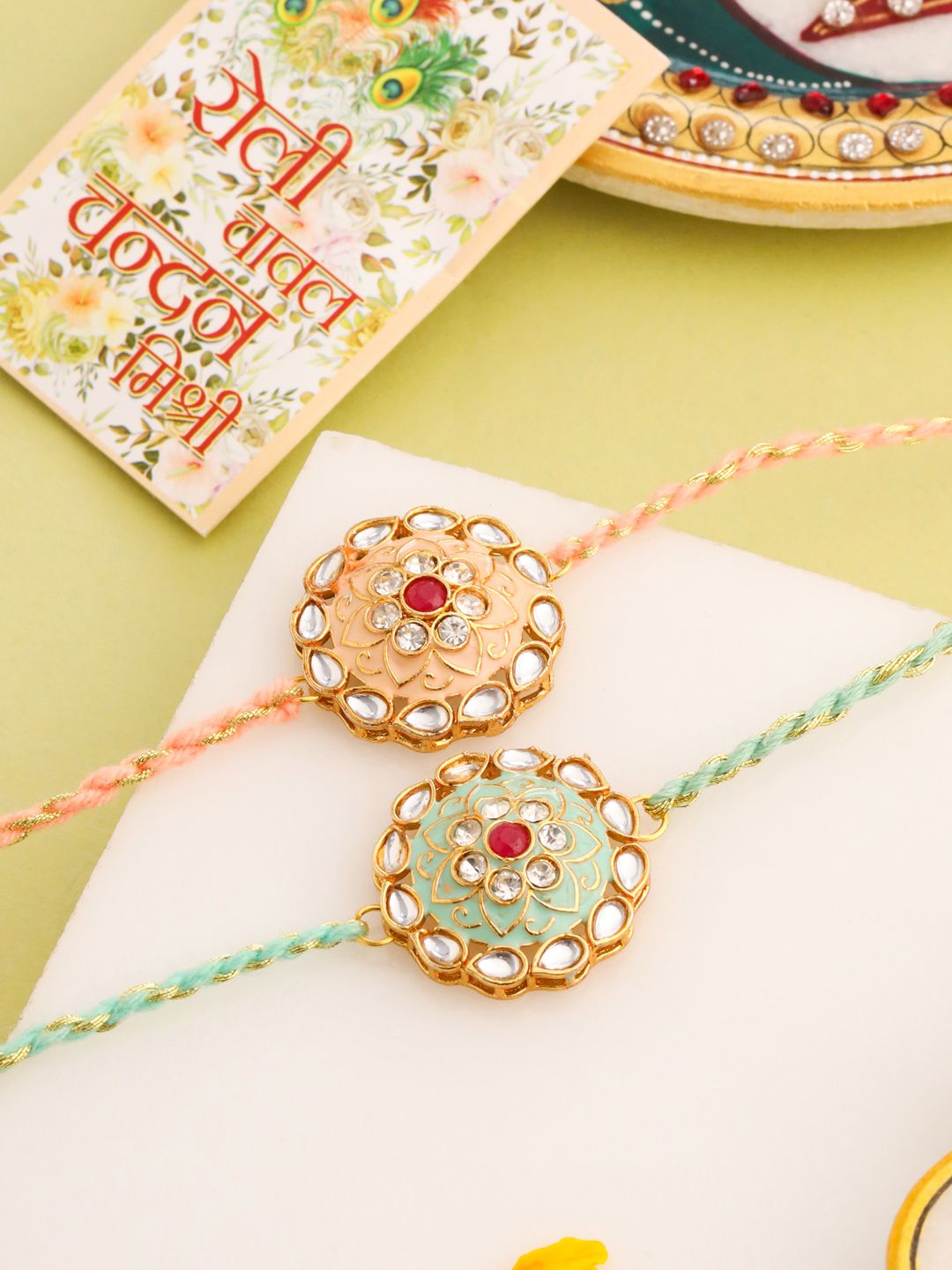 NVR Unisex Set of 2 Kundan Studded Round Floral Rakhi with Roli Chawal Chandan Mishri