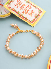 NVR Women Gold Toned Artificial Beads Wraparound Rakhi with Roli Chawal Chandan & Mishri