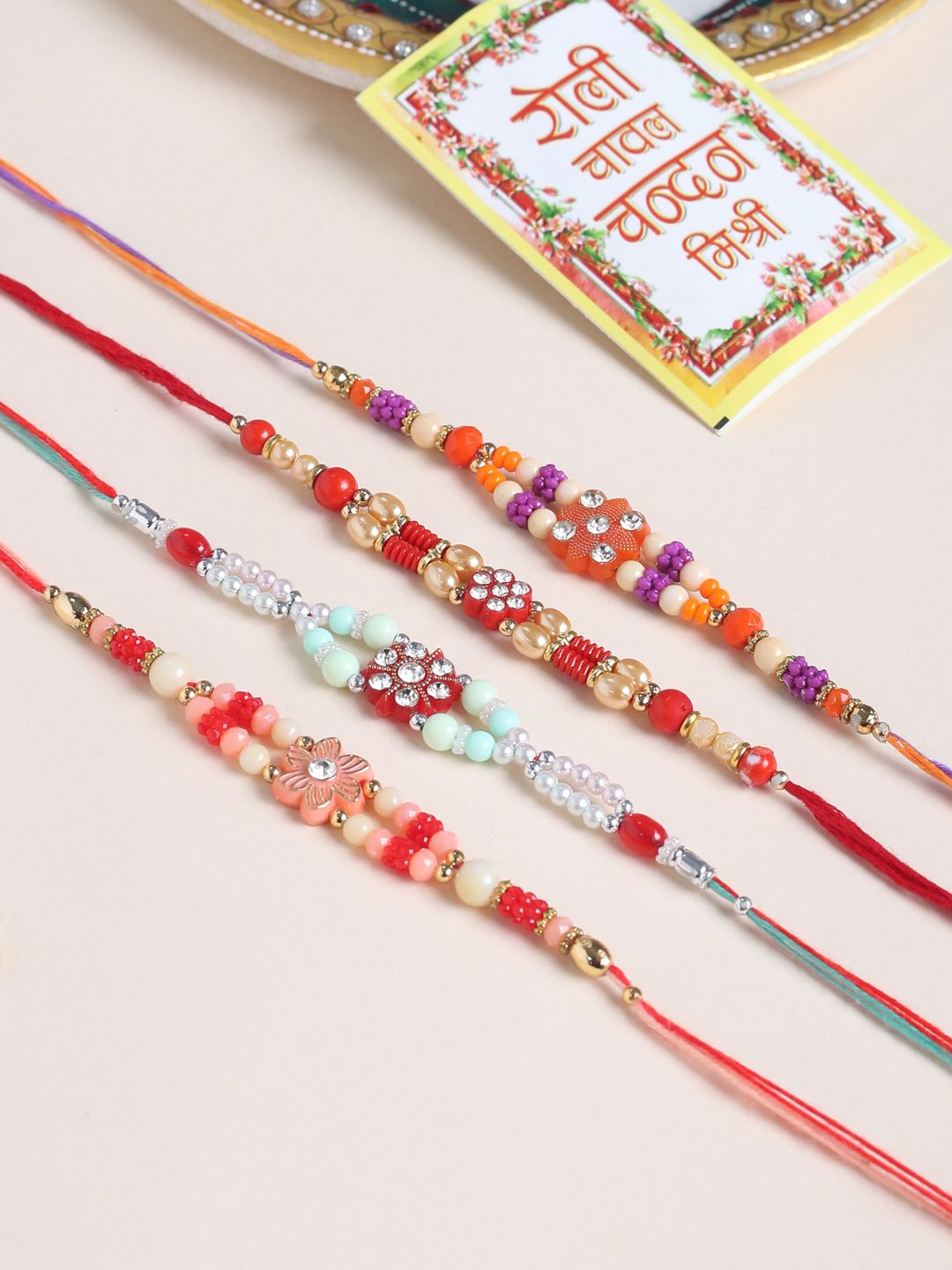 NVR Unisex Set of 4 Floral Artificial Stones and Beads Thread Rakhi With Roli Chawal